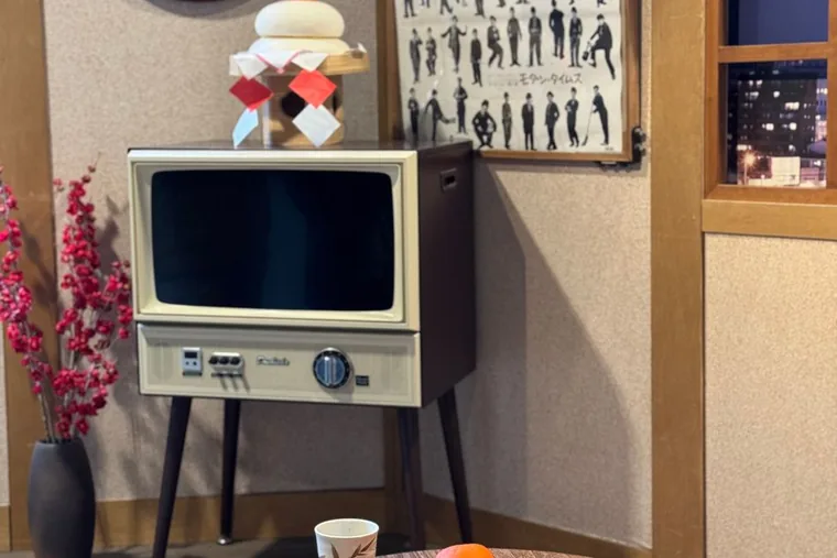 A Japanese-style living room with a low table and a bowl of tangerines